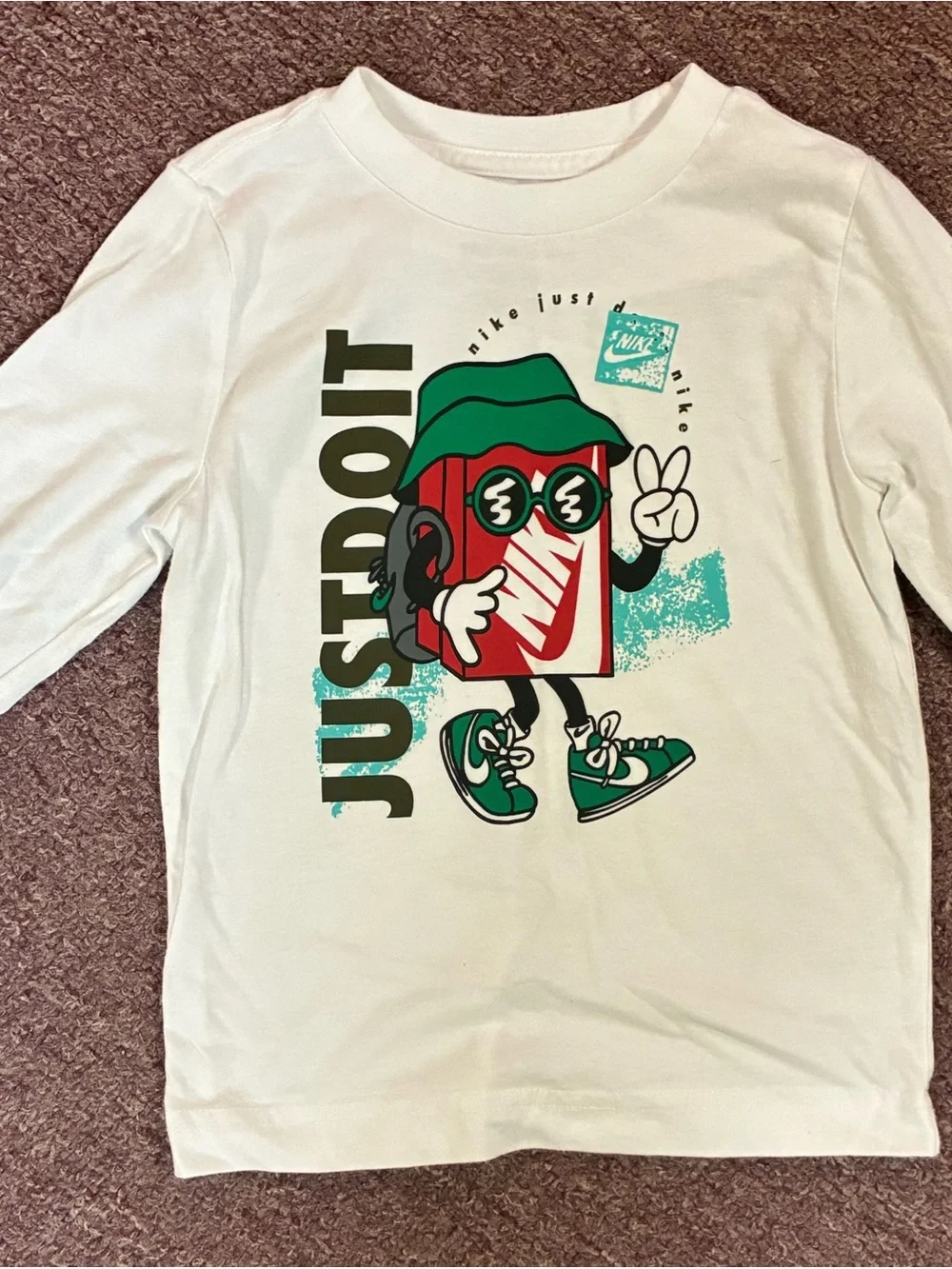 Nike White Long-Sleeve Tee with Colorful 'Just Do It' Character Graphic